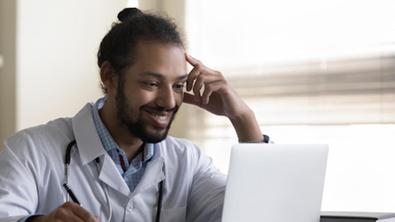 young male doctor at computer