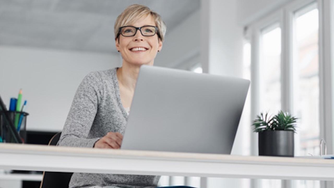 low angle view of business woman sitting at laptop